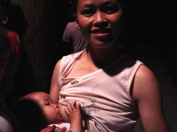 photo of China, Guanxi province, Dong woman breastfeeding baby
