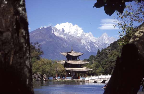 photo of China, Yunnan province, Lijiang, Hei Long Tan (Black Dragon Pond) pavilion and lake view with the Snow Mountain of Jade Dragon (5596m) behind, an extremely popular image on posters all over China
