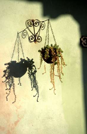 photo of Cuba, flower pot hanging in front of a Cuban house