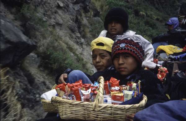 photo of Ecuador, Riobamba-Huigra train (ferrocaril) ride, very popular with tourists, as you can enjoy the wonderful landscape from the top of the roof, which is packed with people and these Ecuadorian boys selling sweets and tobacco to them