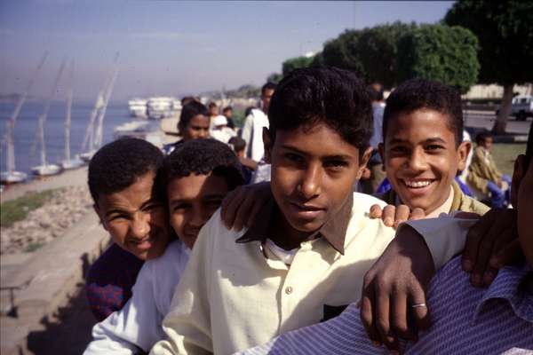 photo of Egypt, Aswan, Egyptian kids on the border of the Nile where the felucca's leave for the trip to Luxor