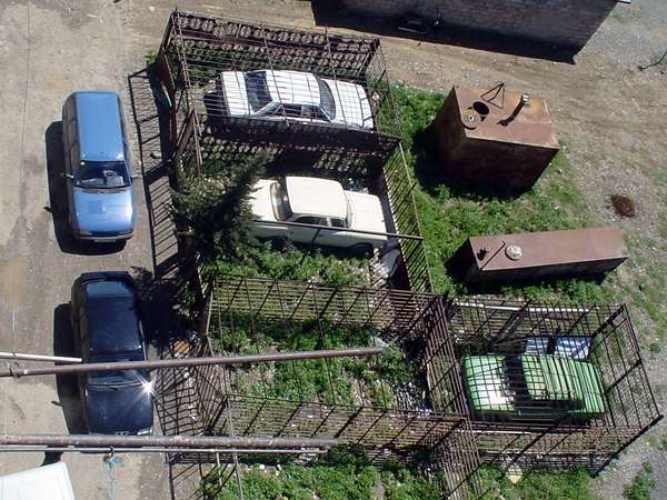 photo of Republic of Georgia, cars parked in iron cages in the outskirts of Tbilisi
