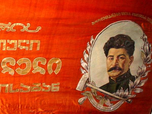 photo of Republic of Georgia, red Soviet flag of a young Stalin in the second world war museum in his birthplace Gori