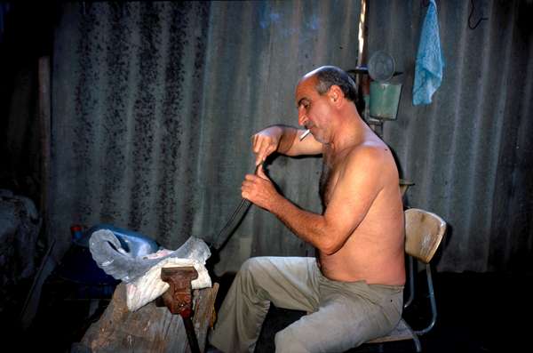 photo of Republic of Georgia, Georgian man making the horn of a goat into a wine drinking horn