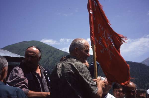 photo of Republic of Georgia, Svaneti, village of Kala, ceremony during the celebrations of Kvirikoba, the priest reads little notes given to him from villagers and people that want to be blessed