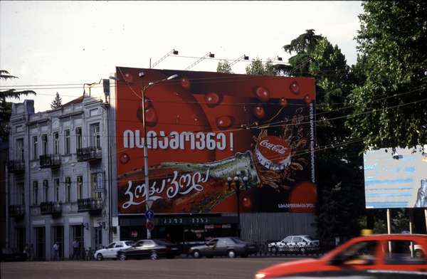 photo of Republic of Georgia, central Tbilisi, street with publicity billboard for Coca Cola in Georgian
