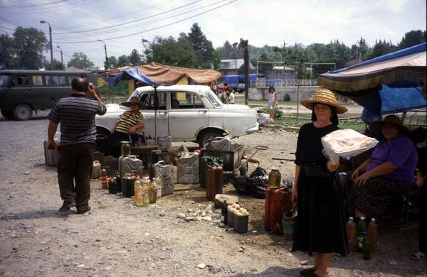 photo of Republic of Georgia, West Georgia, Zugdidi, women selling fuel and engine oil from cans and bottles