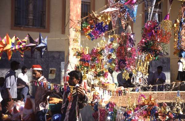 photo of India, Goa, Margao, Indian market vendor selling Christmas decoration and stars
