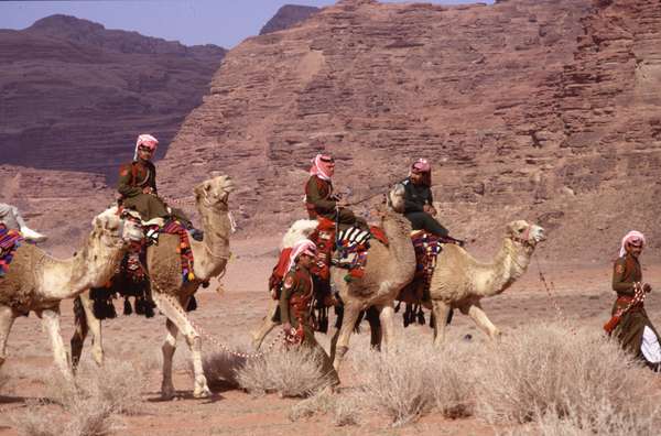 photo of Jordan, Wadi Rum desert, colorfully uniformed Bedouin Desert Police on camels