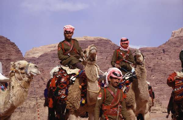 photo of Jordan, Wadi Rum desert, colorfully uniformed Bedouin Desert Police on their camel