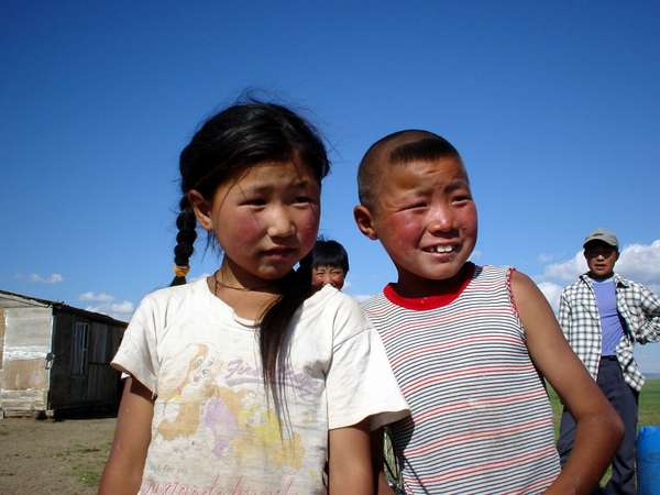 photo of Mongolia, Mongolian children and their family in front of their yurt