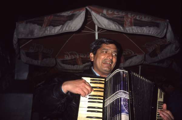photo of Romania, Bucharest, roma (romani) gypsy playing accordion