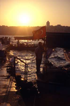 photo of Turkey, Istanbul, sunset over the Bosphorus and fish restaurants in boats