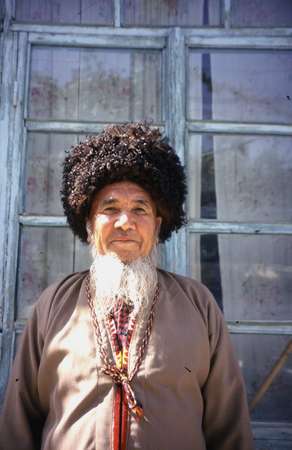 photo of Turkmenistan, South Western mountain area, old Turkmen man with long white beard and black Telpek, the traditional Turkmen fur hat, made of sheep wool