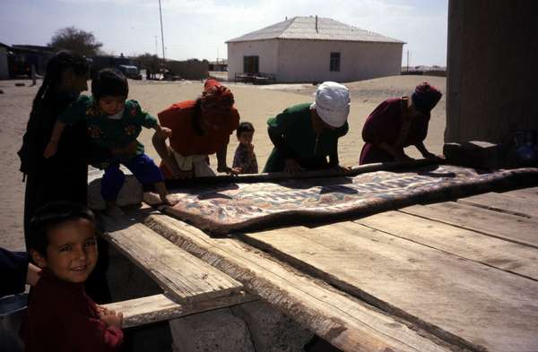 photo of Turkmenistan, Kara Kum desert, around Yerbent (Jerbent), Turkmen women making a carpet