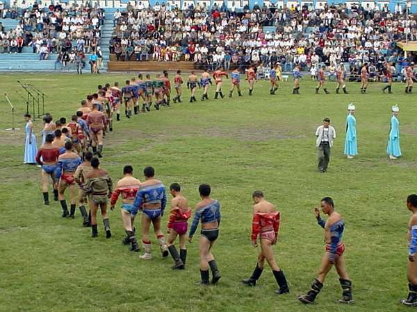 photo of Tuva, Kyzyl, Tuvan wrestlers entering the stadium for a competition in traditional-style wrestling (kures, kurash, kuresh). The first wrestler to reach the ground with a part of his body other than his feet, or to be lifted off the ground entirely, loses the match