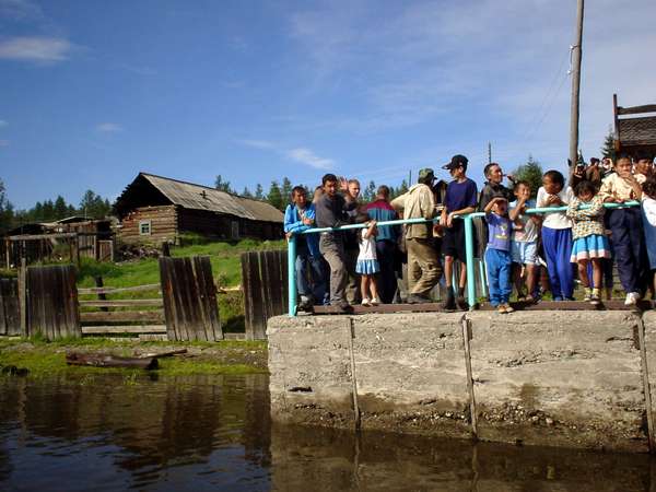 photo of Tuva, on the Yenisey (Yenisei) river, the ferry boat from Kyzyl to Toora Chem (Toora-Xem, Toora-Khem), Tuvans waiting at the river port of a tiny wooden village along the stream