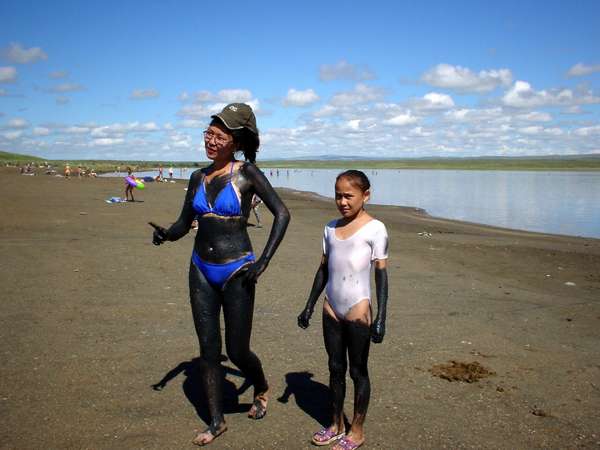photo of Tuva, two Tuvan girls covered  with black mud on the beach of the alkaline Lake Khadyn, south of the capital Kyzyl