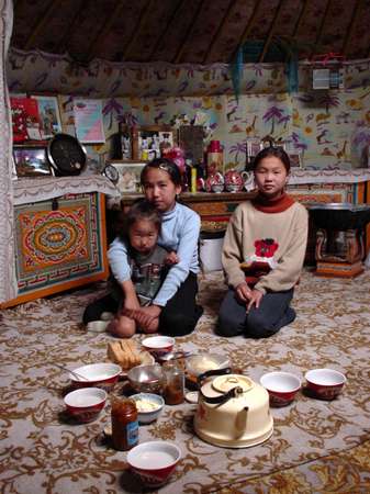 photo of Tuva, south of Kyzyl, around Erzin, east of Naryn, Tuvan children with milk products in a yurt (ger, nomadic tent)