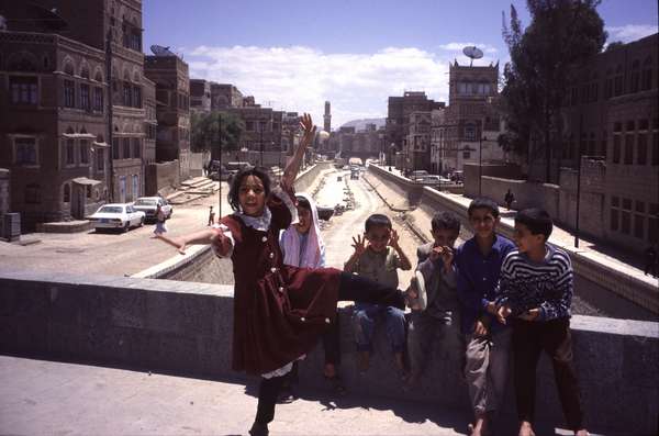 photo of Yemen, Sanaa, Yemeni children on a bridge over a dried out river canal which is temporary used as a road