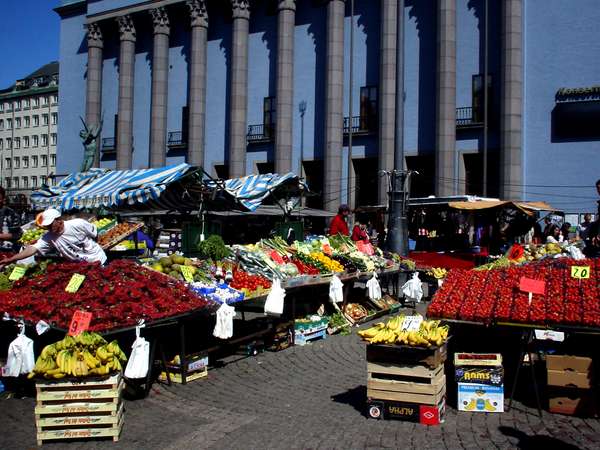 photo of Sweden, Stockholm, market stalls on the Hötorget Fruit Market in central Stockholm with the Konserthuset on the background
