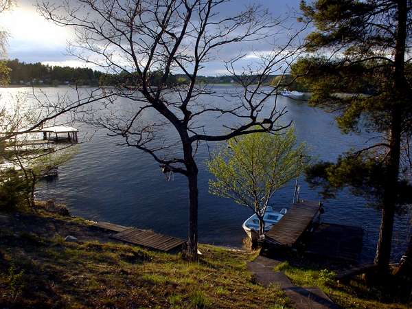 photo of Sweden, Stockholm area, view of sunset above lake Mälaren from a stuga (Summer House) on the tiny island of Kanan with in the background the island of Ekerö, it takes half an hour rowing with the little boat to get there 