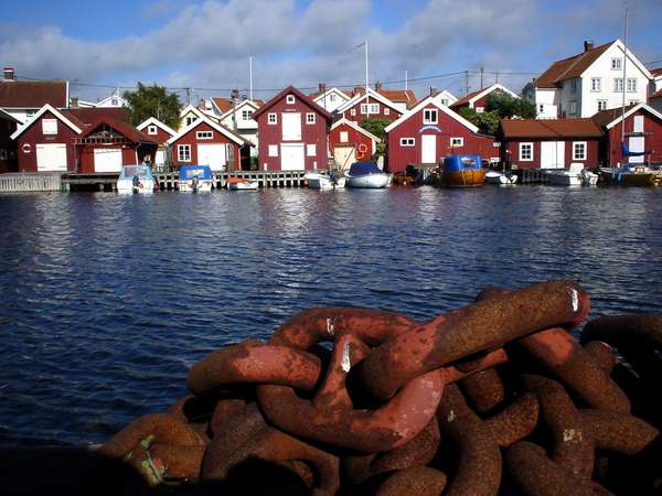 photo of Sweden, West Coast, Göteborg (Gothenburg) archipelago, red houses and a boat chain on the island of Gullholmen
