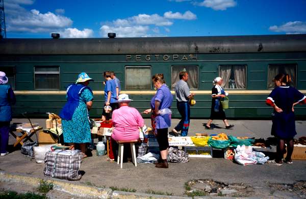 photo of Russia, along the trans Siberian railway, food market vendors in a train station in Siberia