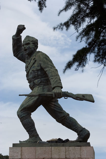 Albania photo of Tirana: Communist Statue of the Unknown Partisan waving his comrades into battle with one hand and his rifle in the other. 