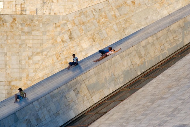 TIRANA, photo of kids children sliding from the PYRAMID, a communist building, the former Enver Hoxha museum. 