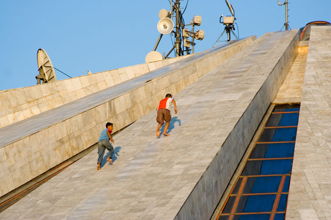 TIRANA, photo of kids children sliding from the PYRAMID, a communist building, the former Enver Hoxha museum. 