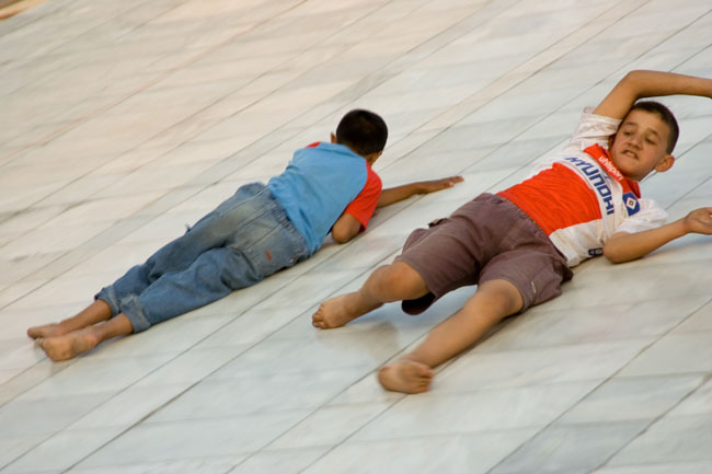 TIRANA, photo of kids children sliding from the PYRAMID, a communist building, the former Enver Hoxha museum. 